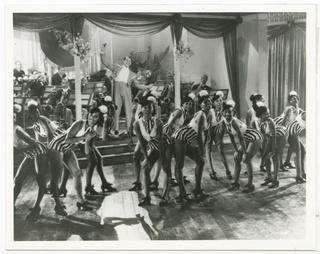 Print of Cab Calloway with his band and dancers from the movie The Singing Kid