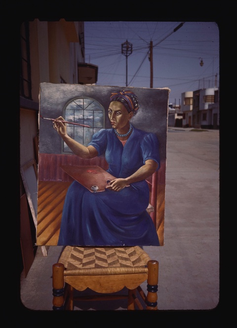 A photograph of a painting leaning against a chair on an empty city street. The painting depicts a seated woman wearing a blue dress, painting at an easel. 
