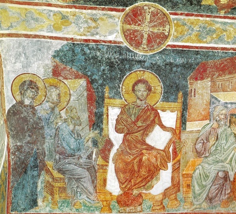 A colorful depiction of saints with golden halos surrounding Jesus on a throne.