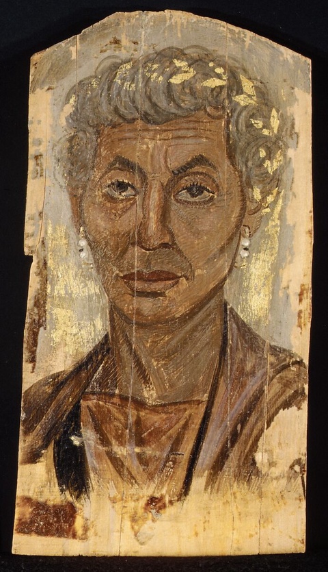 A portrait of an elderly woman in classical dress. A gold wreath adorns her gray hair.